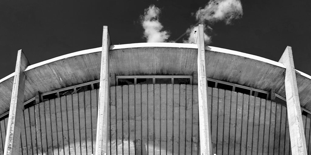grayscale photo of stadium under clear sky